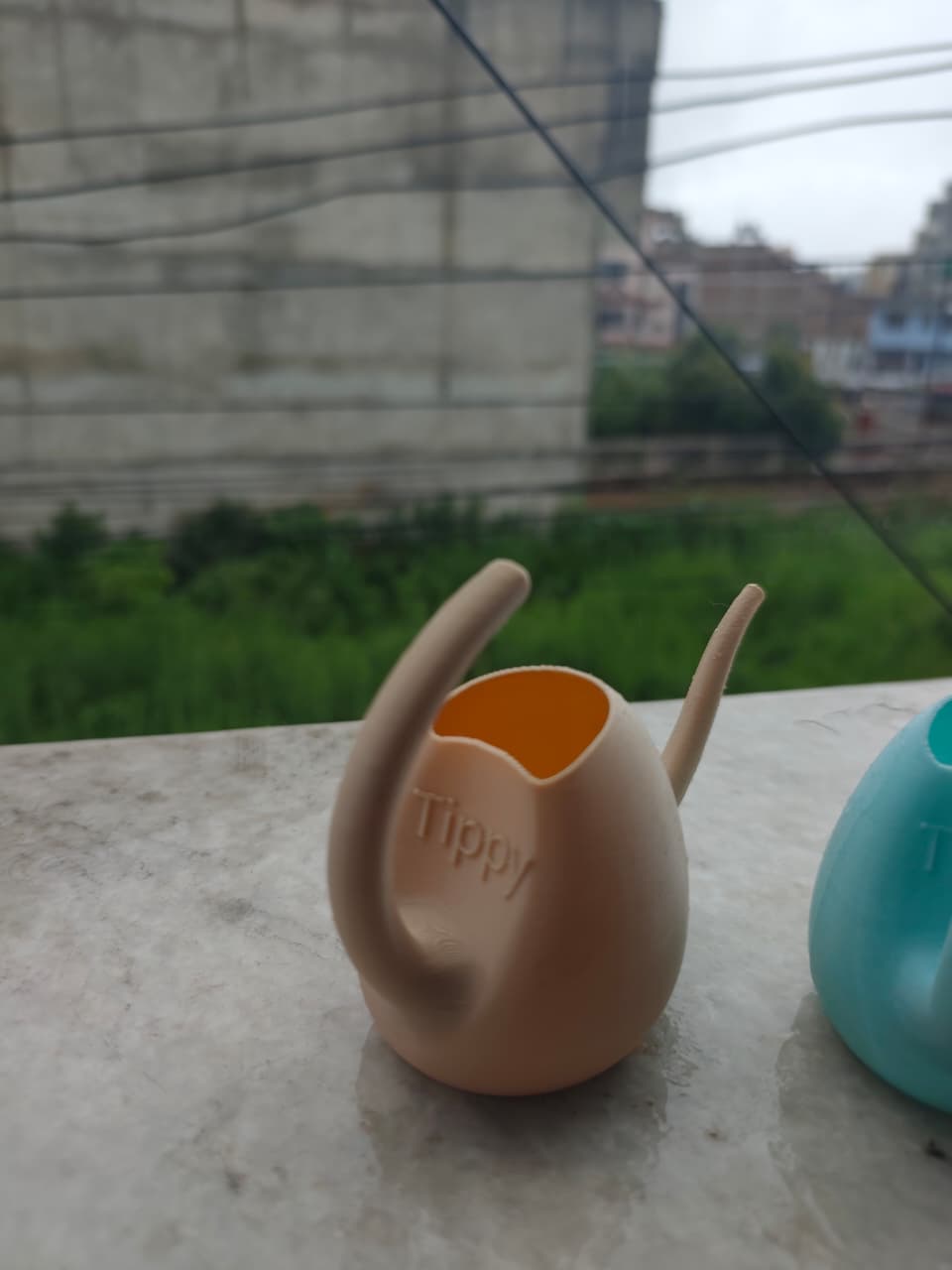 Tippy watering can closeup with embossed Tippy logo